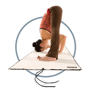 Yogi doing forward fold on a PadaPath Wet Traction Hemp Yoga Towel